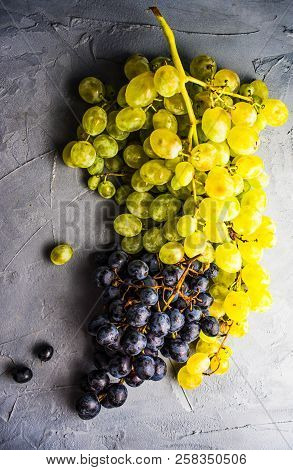 Organic Ripe Grape And Vintage Corkscrew On Rustic Background As A Wine Concept