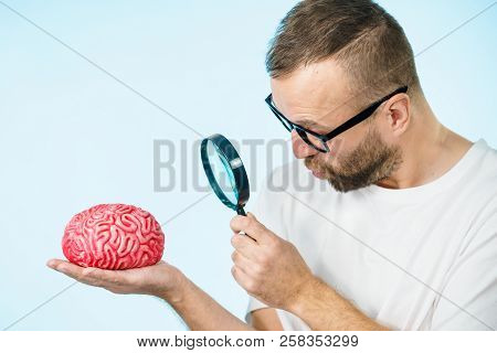 Adult Nerd Man Wearing Eyeglasses Looking At Human Brain Model. Thinking And Intelligence Conept