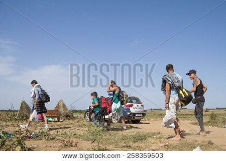 Tovarnik, Croatia - September 19, 2015: Group Of Refugees, From Passing In Front Of A Croatian Polic