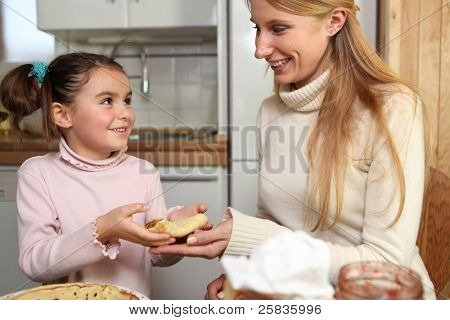 Menina dando um crepe de sua mãe