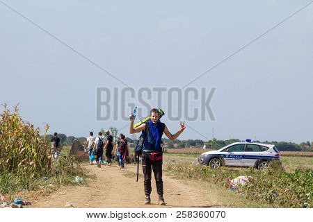 Tovarnik, Croatia - September 19, 2015: Group Of Refugees, From Passing In Front Of A Croatian Polic