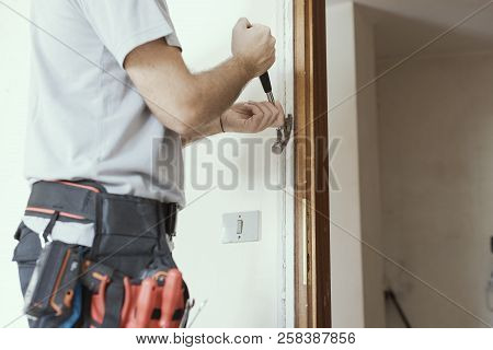 Carpenter Removing An Old Door At Home