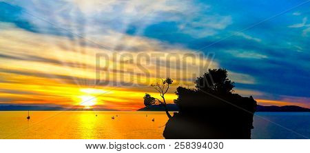 Dramatic Sunset Over The Adriatic Sea With Kamen Brela - Tiny Famous Island In Brela, Makarska Rivie
