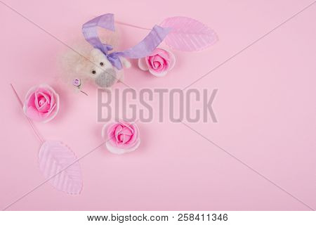 Tiny Unicorn Toy Made Of Wool, Handmade Rose Buds And Handmade Pink Leaves On A Pastel Pink Backgrou