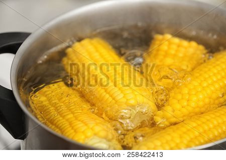 Stewpot With Boiling Water And Corn Cobs, Closeup