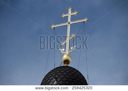 Golden Cross On The Dome Of The Temple. Gold Cross On A Blue Sky