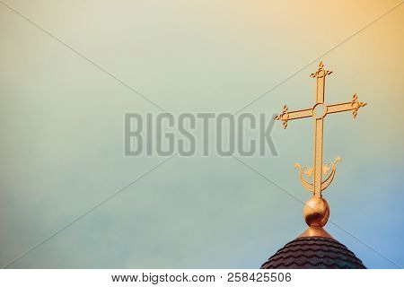 Golden Cross On The Dome Of The Temple. Gold Cross On A Blue Sky