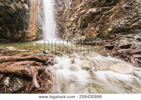 Autumn Waterfall With Rocks And Leaves In Troodos Mountains In Cyprus