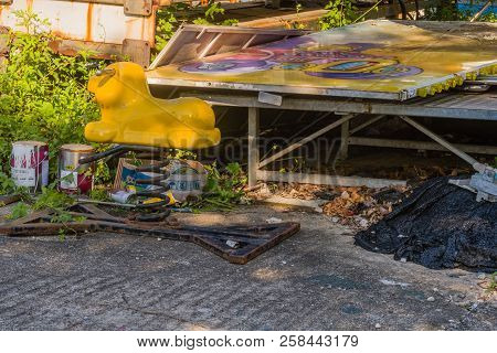 Seoul, South Korea; September 8, 2018; Yellow Piggy Bouncy Spring Ride Sitting Next To Old Sign And 