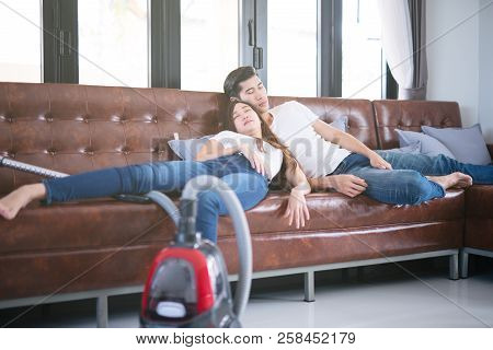 Man Husband Cleaning The House Helping Wife And Cleaning Lady Taking A Nap On Sofa After Cleaning Th