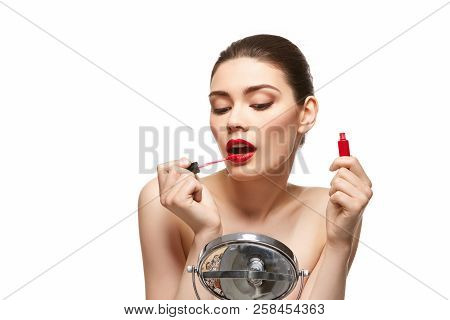 Girl Applying Red Lipstick Isolated On White