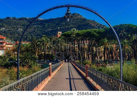 View Towards The Center Of The Medieval Town Of Vintimiglia From The Bridge Above The River Roya In 