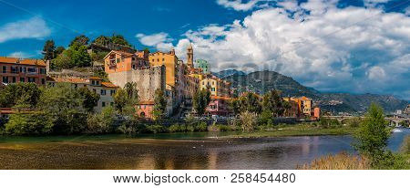 Colorful Old Buildings Perched Atop A Hill In The Medieval Town Of Vintimiglia In Italy, Just Across