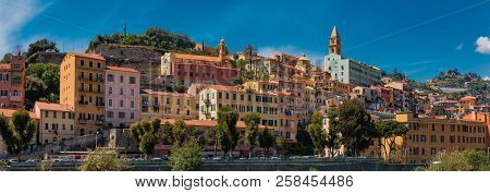 Colorful Old Buildings Perched Atop A Hill In The Medieval Town Of Vintimiglia In Italy, Just Across