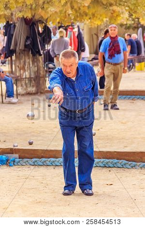 Cannes, France - October 17, 2013: Senior Man Plays Petanque With A Metal Ball In A Park