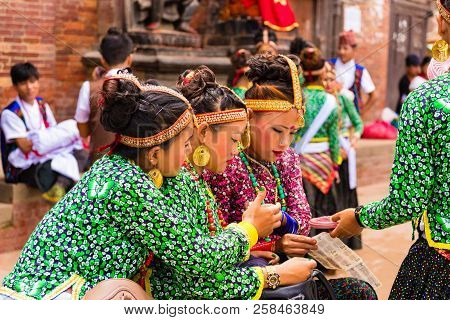 Group Of Dancers Wearing Traditional Costumes In Patan Durbar Square, Kathmandu Valley, Nepal