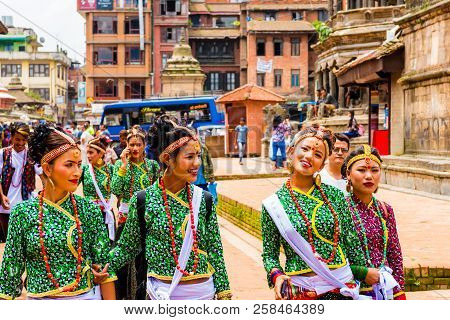 Group Of Dancers Wearing Traditional Costumes In Patan Durbar Square, Kathmandu Valley, Nepal