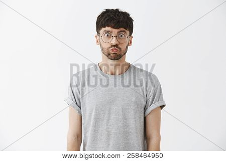 Waist-up Shot Of Playful Good-looking And Stylish Caucasian Male Model With Beard In Grey T-shirt Ho