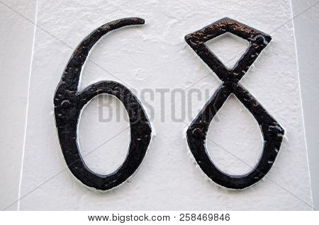 Number 68 In Gothic Style Carved And Painted On The Outside Of A House In Mayfair, London.