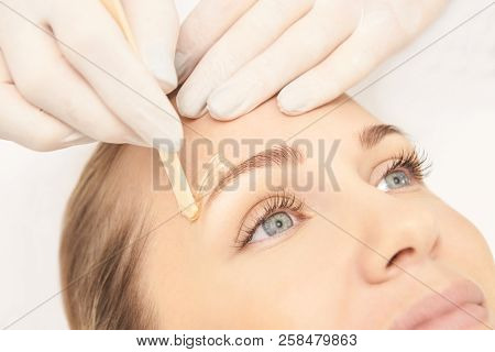 Sugar Hair Removal From Woman Body. Wax Epilation Spa Procedure. Procedure Beautician Female. Eyebro