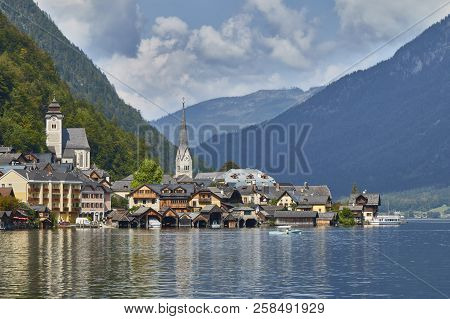 Hallstatt Village Landscape With Old Buildings Reflected In Blue Lake.