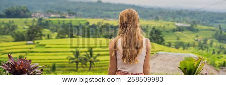 Young Woman Traveler On Beautiful Jatiluwih Rice Terraces Against The Background Of Famous Volcanoes