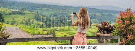 Young Woman Traveler On Beautiful Jatiluwih Rice Terraces Against The Background Of Famous Volcanoes