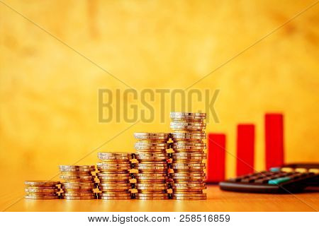 Stacking Gold Coins Image Photo Free Trial Stock Stacking Gold Coins And Red Arrow Graph With Growing Value Calculator Put On The Desk