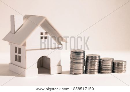 Stacked Coin With Grow Value And Home Model On Gray Background In The Office, Saving Money For Buy A