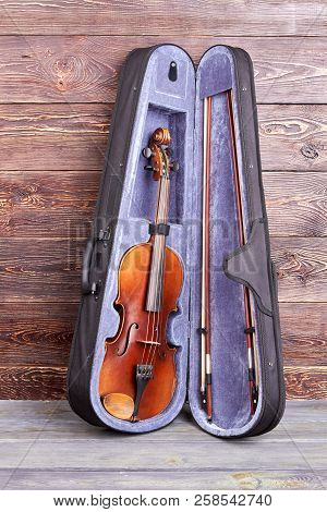 Violin In Case On Wooden Background. Classical Instrument Of Orchestra, Vertical Image.