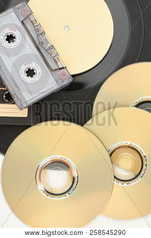 Dvd Discs, Audio Cassettes And Vinyl Record. Compact Discs, Audio Tape And Vinyl Plate Close Up, Ver