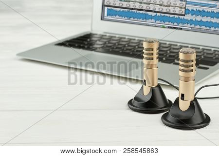 Stereo Recorder Microphones And Laptop. Mini Stereo Microphones And Laptop Computer On White Backgro