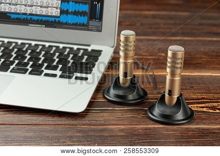 Laptop And Stereo Record Microphone. Mini Stereo Condenser Microphones And Laptop Computer On Brown 