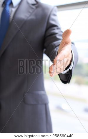 Unknown Business Man Offering Handshake While Standing Straight. Success Cooperation And Agreement C