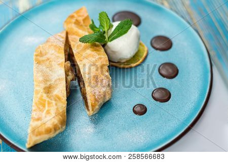 Piece Of Cake With Cheese Balls On A Blue Plate