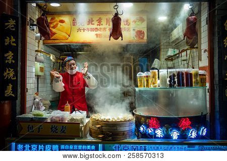 Beijing, China - Dec 20, 2017: Chinese Vendor Of Wangfujing Street Food Market Selling Beijing Duck 