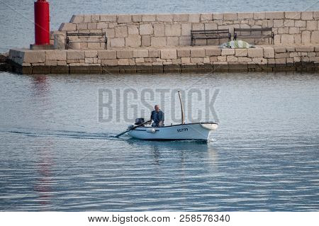 Vinjerac, Croatia - July 28 2018: Local Fisherman In Small Boat Entering Harbor Coming To Town For B