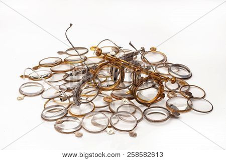 Old Optometric Devices And Set Of Lenses On An Isolated Studio Background
