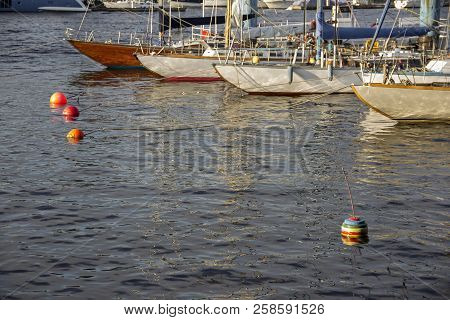 Nautical Part Of A Yacht With Cords, Rigging, Sail, Mast, Anchor, Knots On Yachts Tied Up To Buoys A