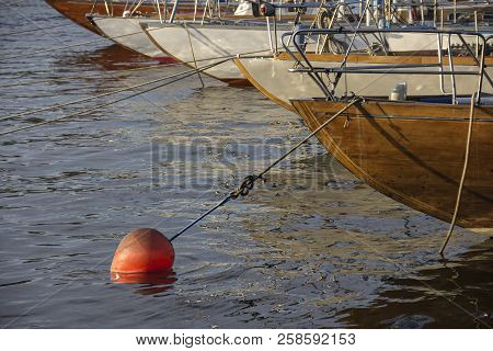 Nautical Part Of A Yacht With Cords, Rigging, Sail, Mast, Anchor, Knots On Yachts Tied Up To Buoys A