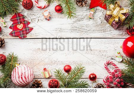 Christmas Composition With Fir Tree Branches And Red Christmas Decorations On White Wooden Backgroun