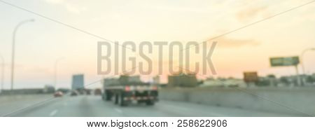 Panoramic Blurry Background Long Vehicles Commute On Interstate Highway At Sunrise