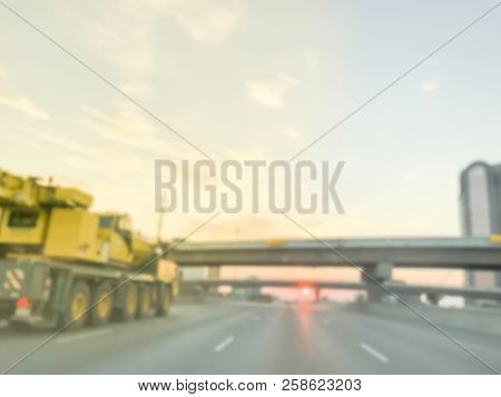 Blurry Background Highway Traffic With Long Vehicles Near Bridge Grade Separation