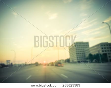 Blurry Industrial Background Highway Long Vehicles With Downtown Skylines At Sunrise