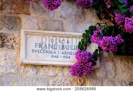 Split, Croatia, September 15, 2016 -  Beautiful Croatian Number Plate Of The Road With Bougainvillea