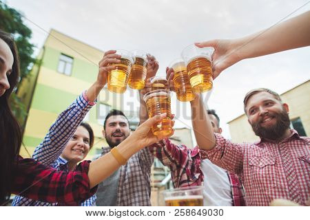 The Group Of Friends Enjoying And Drinking Beer At Outdoor Bar Or Pub. Boiled White Sausages, Served