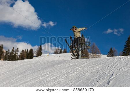 Skier In Action: Ski Jumping In The Mountain Snowpark.