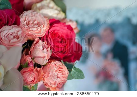 Bridal Bouquet Near Photo Of Newlyweds In Frame