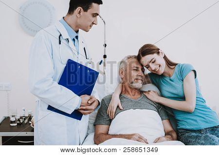 Medic In Hospital With Patient And Girl. People Happy In Clinic. Rehabilitation In Clinic For Patien
