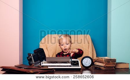 Archaism Type And Style. Little Boy Typewrite On Vintage Typewriter Archaism At Office Desk.